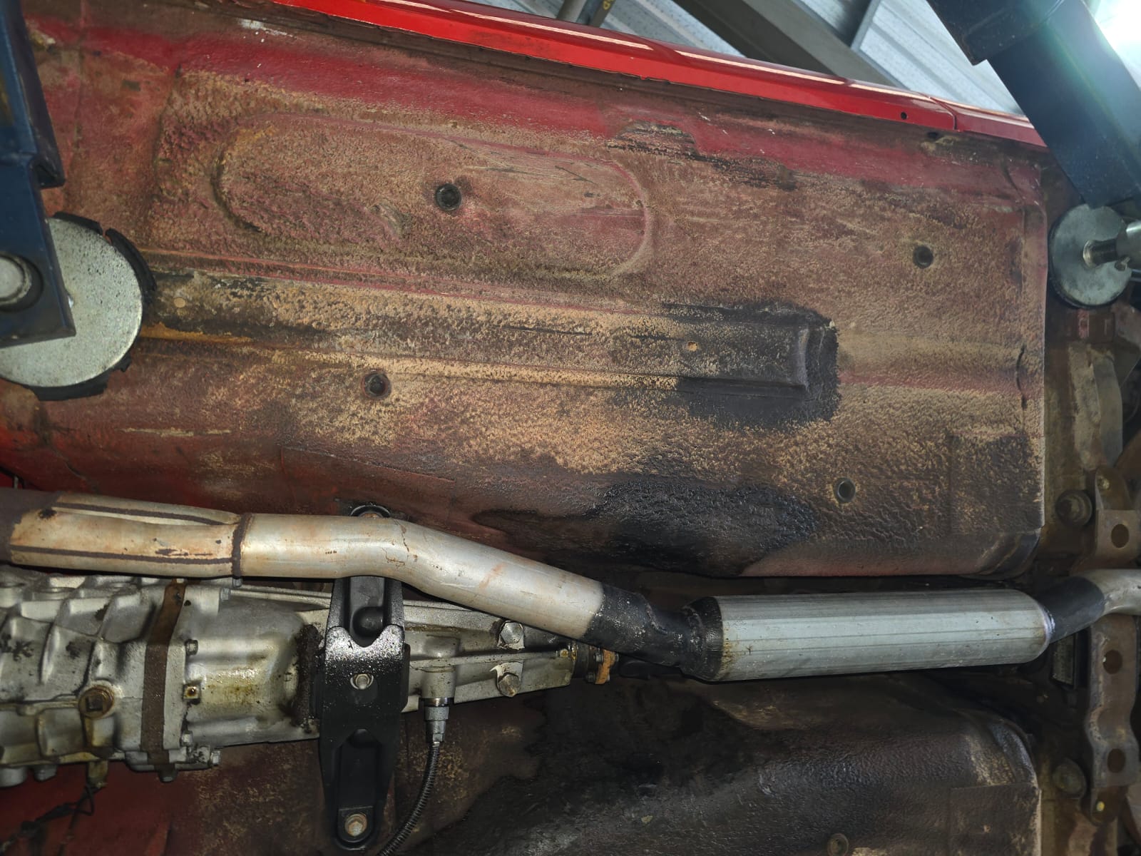 Nissan 240Z floorpan and transmission tunnel area before dry ice blasting