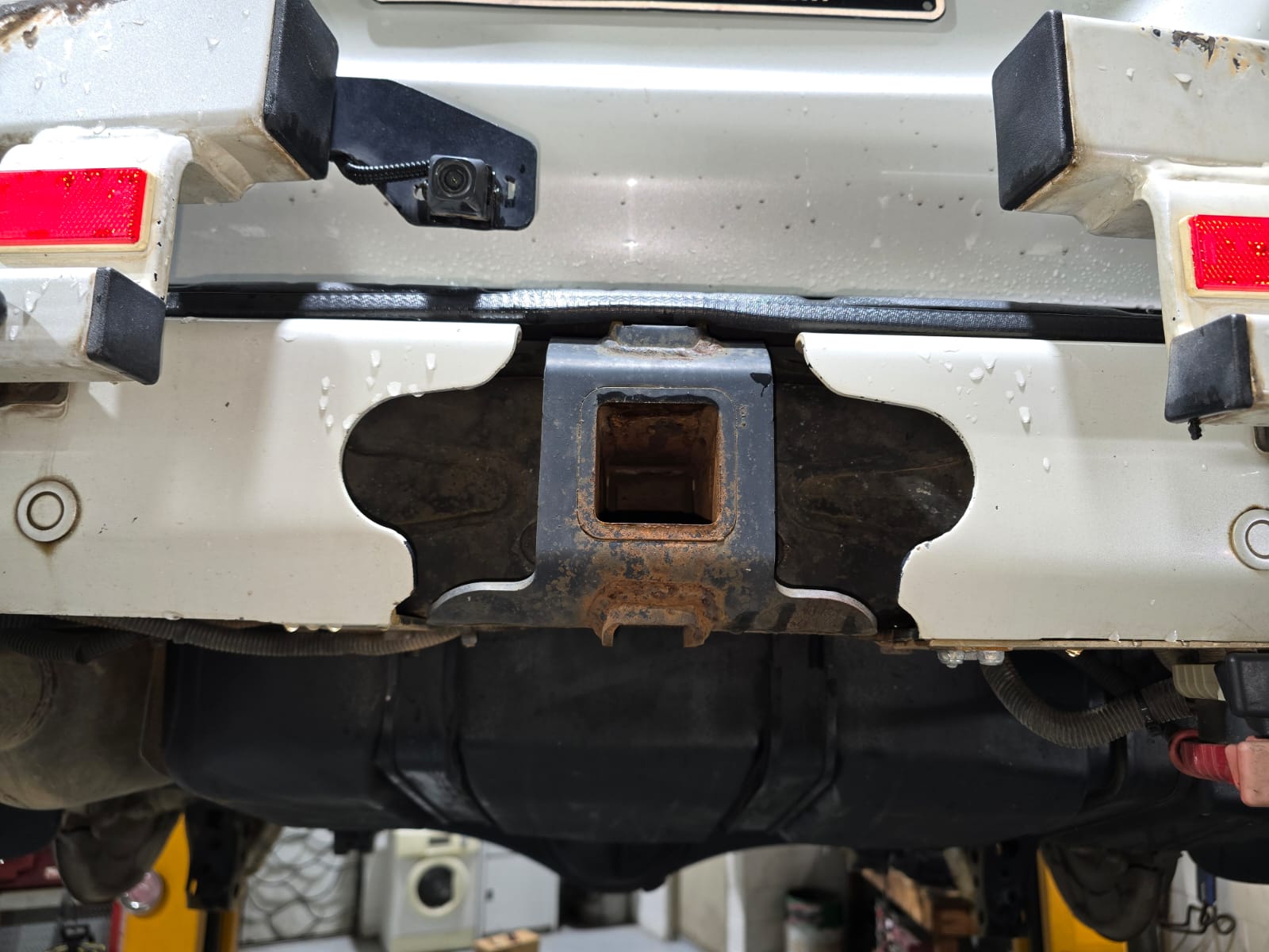 Toyota Land Cruiser rear towbar mount and chassis before dry ice blasting, with surface grime and corrosion staining